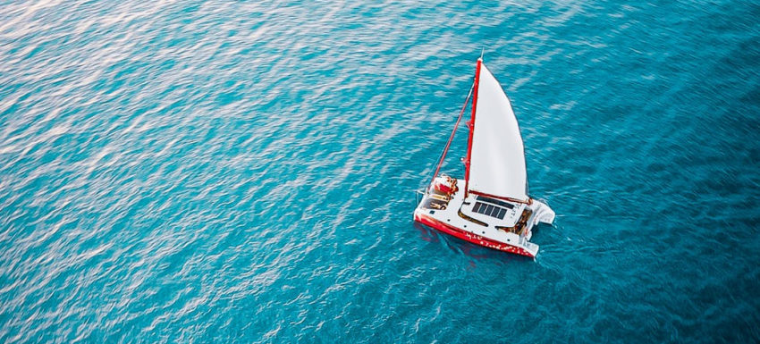 sailboat floating on rippling sea