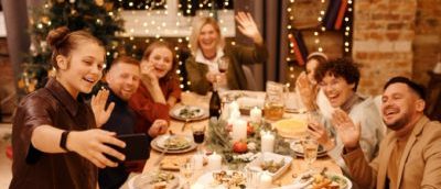 family celebrating christmas dinner while taking selfie